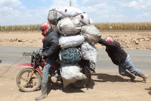 A motorcyclist commonly referred to as 'Boda Boda' in Kenya ferries sacks of charcoal along the Nakuru -Nairobi highway, Nakuru, Kenya, Sept. 16, 2015. Some Kenyan families still use charcoal as the main source of energy consumption due to the high cost of fuel and gas. (Xinhua/Simbi Kusimba)