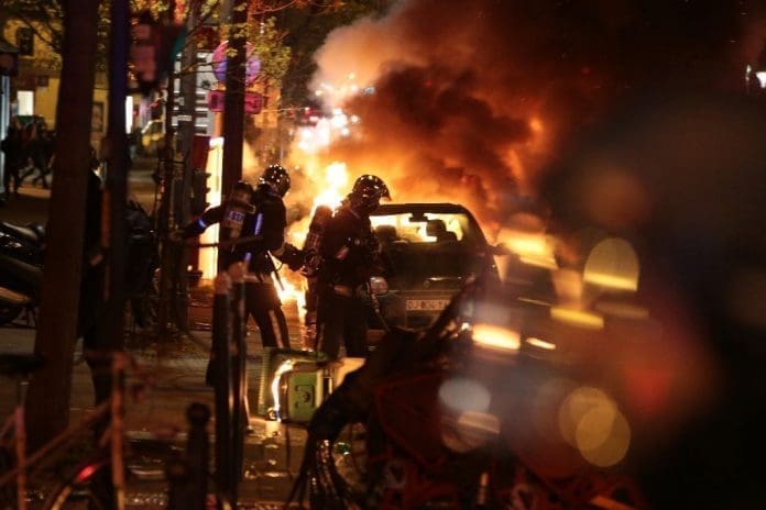 Cars were set alight and clashes erupted as at least 170,000 workers and students took to the streets across France (AFP Photo/Joel Saget)