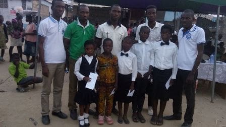 Tettegu children Mr Atukpa in the middle in a group photograph with the participants and the winners.