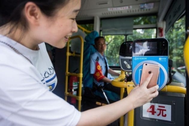 August16, a passenger boards a bus using Paypal. (CFP)