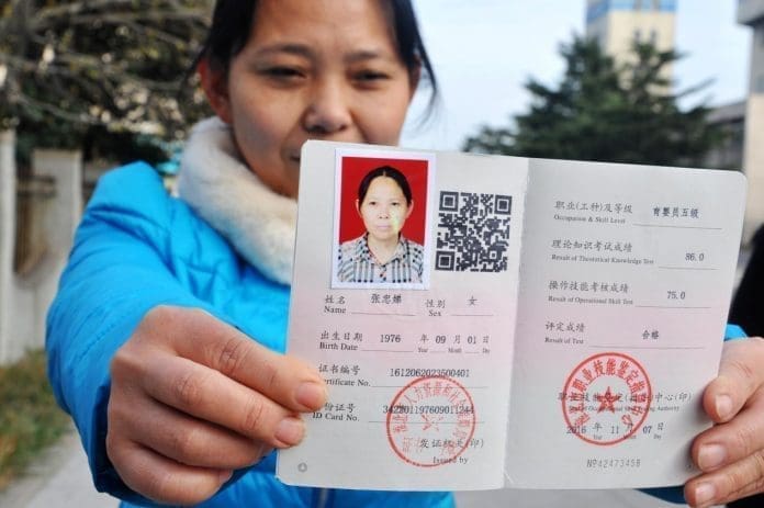 The government has launched skill training to reallocate workers laid off as a result of the effort to addressing overcapacity. Photo shows Zhang Zhongdi, a laid-off worker from Huaibei Mining Group in east China’s Anhui province, is demonstrating her domestic helper certificate. (Photo by Wang Daoyu from People's Daily)