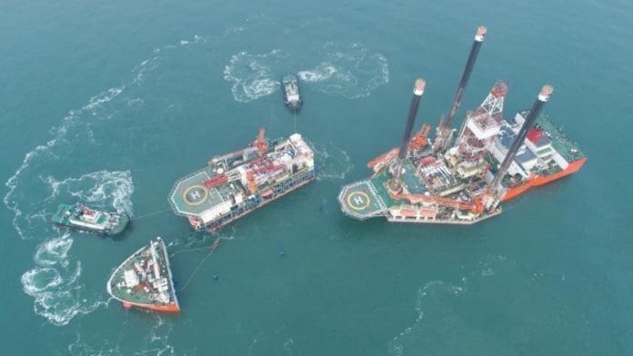 Oil drilling platform Shengli No.4 is in the midst of shipment at the outer anchorage of a port in Yantai, east China’s Shandong province, Feb. 8, 2018. The Shengli No. 4 and the New Shengli No.1 will be sent to Nigeria for oil exploration services. (Photo by Chu Yang from CFP)