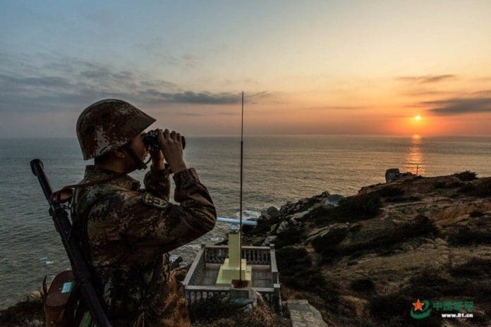 A soldier is patrolling on Beishuang Island in China’s southeastern coastal area on February 14, 2018. (Photo from 81.cn, the website of the People’s Liberation Army)