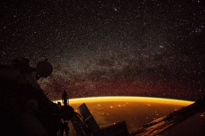 ICON-satellite-to-study-boundary-between-Earths-atmosphere-space The orange hue over Earth, called an airglow and caused by molecules in the atmosphere energized by ultraviolet radiation from sunlight, was caught on camera by an astronaut aboard the International Space Station in 2018. Photo by ISS/Nasreen Alkhateeb/NASA