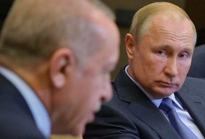 RUSSIA-SOCHI-PUTIN-TURKEY-ERDOGAN-TALKS Russian President Vladimir Putin (R) listens to Turkish President Recep Tayyip Erdogan during their meeting in Sochi, Russia, on Oct. 22, 2019. Russia and Turkey have adopted a joint memorandum on the situation in Syria after the talks between Russian President Vladimir Putin and his Turkish counterpart Recep Tayyip Erdogan in Sochi. According to the memorandum, Moscow and Ankara have agreed to deploy Russian and Syrian forces in zone of the Turkish operation in Syria starting from Wednesday. (Sputnik via Xinhua)