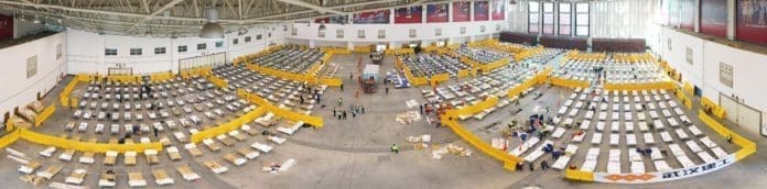 Aerial panoramic photo taken on Feb. 4, 2020 shows the interior of a cultural building complex dubbed "Wuhan Livingroom", which is being converted into a hospital to receive patients infected with the novel coronavirus, in Wuhan, central China's Hubei Province. Wuhan plans to convert three existing venues, including a gymnasium and an exhibition center, into hospitals to receive patients infected with the novel coronavirus (2019-nCoV), the headquarters for the epidemic control said late Monday. (Xinhua/Cai Yang)