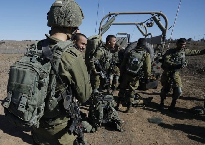 Israeli soldiers gather on November 20, 2019 near the settlement Merom Golan in the Israeli-annexed Golan Heights, seized from Syrian in the 1967 Arab-Israeli war. - The Israeli army carried out a "wide-scale" attack against Iranian forces and Syrian army targets in Syria early on November 20, killing at least 11 fighters, the Israeli army and a monitoring group said. In a rare confirmation of their operations in Syria, the Israeli army said they carried out dozens on strikes against the Iranian elite Quds Force and the Syrian military, in response to four rockets fired at Israel a day before. (Photo by JALAA MAREY / AFP)