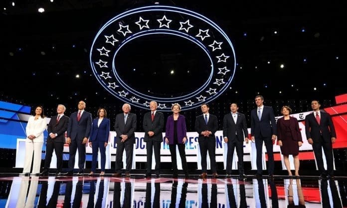Democratic presidential candidates Rep. Tulsi Gabbard, billionaire activist Tom Steyer, Senator Cory Booker, Senator Kamala Harris, Senator Bernie Sanders, former Vice President Joe Biden, Senator Elizabeth Warren, South Bend Mayor Pete Buttigieg, entrepreneur Andrew Yang, former Rep. Beto O''Rourke, Senator Amy Klobuchar and former Housing Secretary Julian Castro pose together at the start of the fourth Democratic U.S. 2020 presidential election debate at Otterbein University in Westerville, Ohio October 15, 2019.