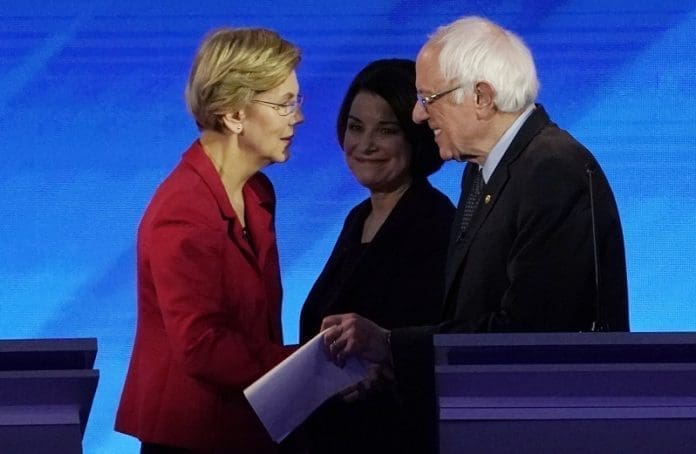 Democratic 2020 U.S. presidential candidate Senator Elizabeth Warren talks with Senator Bernie Sanders as Senator Amy Klobuchar looks on at the conclusion of the eighth Democratic 2020 presidential debate at Saint Anselm College in Manchester, New Hampshire, U.S., February 7, 2020. REUTERS/Brian Snyder
