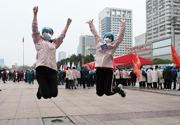 The largest Fang Cang makeshift hospital in the epicenter Wuhan, in Central China's Hubei Province, purposely built and designed for COVID-19 treatment, closed on Monday. The two doctors are happy celebrating for it. Photo by Jin liusi/People’s Daily online