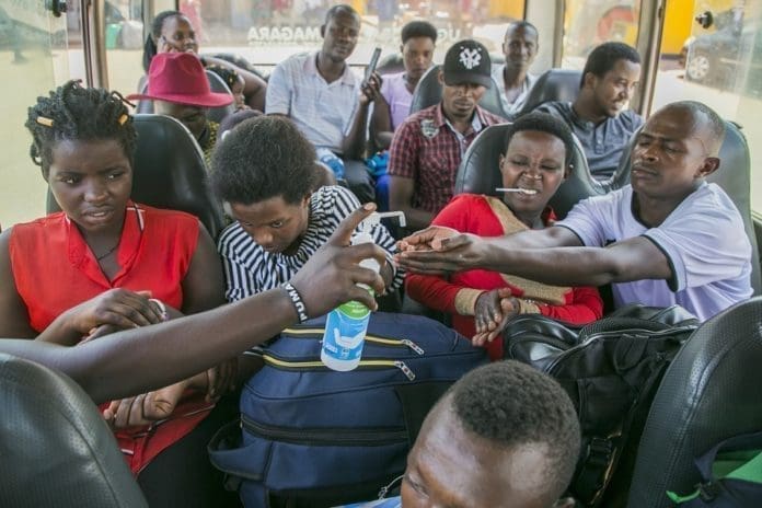 Bus passengers sanitize their hands in Kigali, capital city of Rwanda, March 14, 2020. Rwanda on Saturday registered its first case of the novel coronavirus (COVID-19), the ministry of health said here. (Xinhua/Cyril Ndegeya)