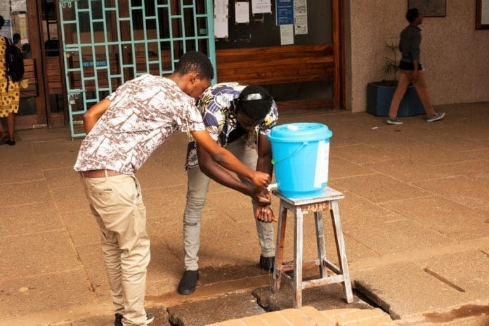 Students wash their hands before entering the library in Blantyre, Malawi, March 23, 2020. Malawi President Peter Mutharika has declared a state of national disaster in Malawi over COVID-19 and he has since ordered closure of all public and private schools, colleges and universities effective Monday. (Xinhua/Joseph Mizere)