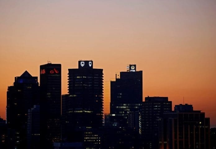 FILE PHOTO: The buildings with the logos of three of South Africa's biggest banks, ABSA, Standard Bank and First National Bank (FNB) are seen against the city skyline in Cape Town, South Africa, September 3, 2017.REUTERS/Mike Hutchings/File Photo