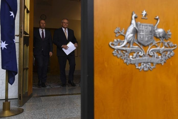 Australian Prime Minister Scott Morrison (R) and Australian Treasurer Josh Frydenberg (L) arrive to speak to the media prior to a press conference at Parliament House in Canberra, Australia, 12 March 2020. Morrison announced an economic stimulus package, worth 17.6 billion Australian dollar (around 11.4 billion US dollar) for the fiscal year, to keep the Australian economy from entering into a recession due to the coronavirus epidemic. EPA/LUKAS COCH AUSTRALIA AND NEW ZEALAND OUT