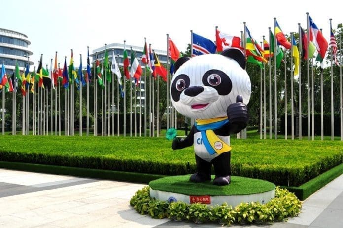 A CIIE mascot stands outside the venue of the 3rd CIIE in Shanghai, July 25. (Photo by Yan Daming/People’s Daily Online)