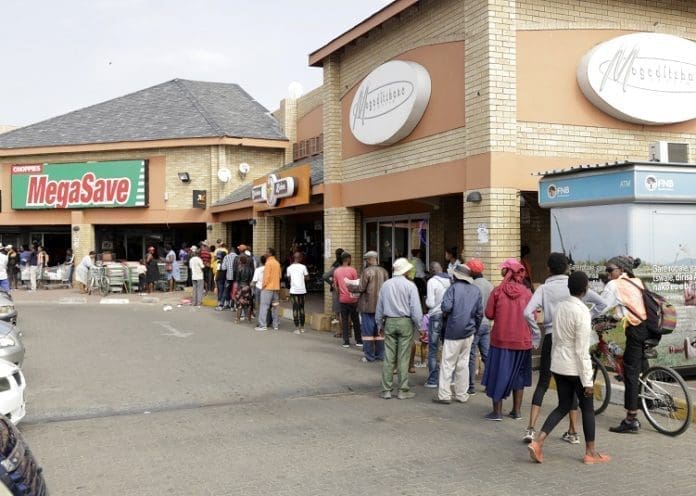 People queue outside a supermarket in Gaborone, capital of Botswana, April 2, 2020. Botswana's President Mokgweetsi Masisi has declared a state of emergency following confirmation of three coronavirus cases in that country. He has also announced a lockdown beginning on April 2 for 28 days. (Xinhua/Tshekiso Tebalo)
