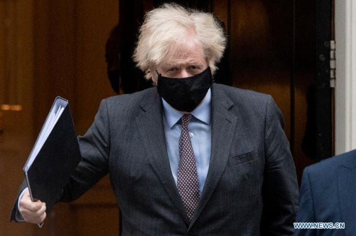 British Prime Minister Boris Johnson leaves 10 Downing Street for the House of Commons in London, Britain, on Feb. 22, 2021. Johnson announced Monday that schools in England will reopen from March 8 as part of the "roadmap" to ease the current coronavirus lockdown. (Photo by Ray Tang/Xinhua)