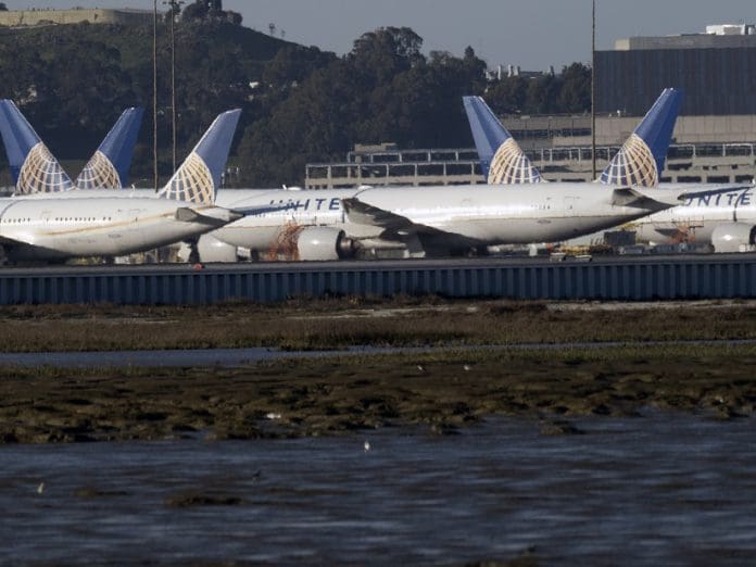 United Airlines planes sit on the tarmac at the San Francisco International Airport (SFO) in San Francisco, California, USA, 22 February 2021. Federal regulators and United Airlines recently announced they will be grounding 24 Boeing 777 aircraft powered by Pratt & Whitney 4000 series engines, the same engine used in the United Flight 328, tail number N772UA incident that experienced a right engine failure that scattered parts over a neighborhood in Colorado bound for Honolulu, Hawaii and made an emergency on its return to Denver International Airport. EPA/JOHN G. MABANGLO