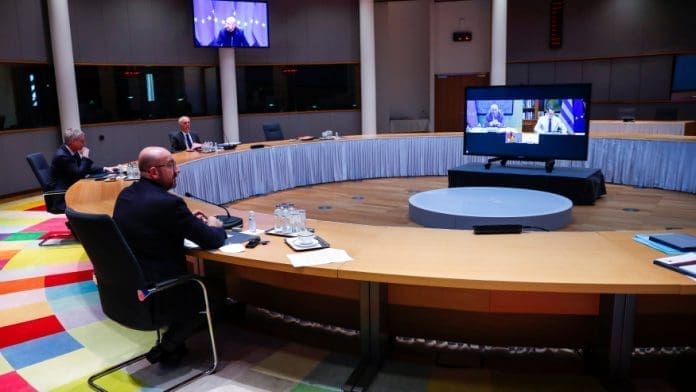 Belgium EU Summit European Council President Charles Michel, left, talks during a video conference with the leaders of Germany, France, Portugal and Greece, on the screen, ahead of the EU summit at the European Council headquarters in Brussels, Tuesday, March 23, 2021. (AP Photo/Francisco Seco, Pool)