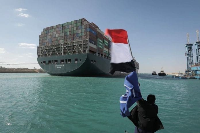 Cargo ship stuck in Suez Canal freed A worker waves the Egyptian flag as the "Ever Given" container ship operated by the Evergreen Marine Corporation, sails with tugboats through the Suez Canal, after it was fully freed and floated. Egypt's Suez Canal Authority announced that the stranded massive container ship that has blocked the Suez Canal for nearly a week, has been fully dislodged and successfully floating in the canal. (best quality available) Photo: -/Suez Canal Authority/dpa