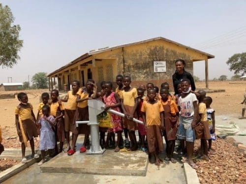 Ms Kenndicta A-ensonga Ajene with some pupils at the borehole Ms Kenndicta A-ensonga Ajene with some pupils at the borehole
