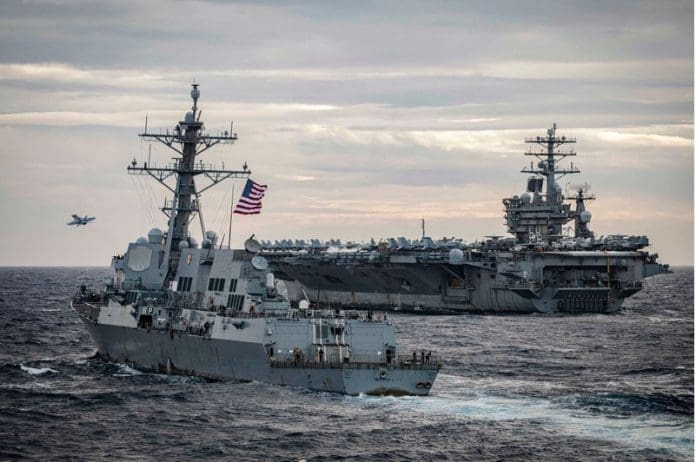 FILED - The Arleigh Burke-class guided-missile destroyer USS Sterett (L) sails alongside the USS Nimitz aircraft carrier and the USS Theodore Roosevelt aircraft carrier (not pictured) during a military exercises conducted in the disputed waters of the South China Sea. Top defence officials from the Philippines and the United States held talks on Sunday, including on the disputed South China Sea, where large numbers of Chinese vessels had been spotted recently. Photo: Markus Castaneda/US Pacific Fleet/dpa - ATTENTION: editorial use only and only if the credit mentioned above is referenced in full