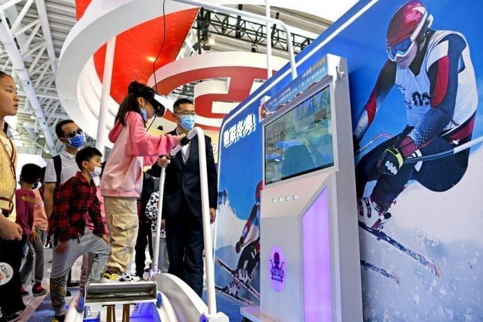 A primary school student experiences virtual skiing events of the Beijing 2022 Olympic Winter Games at the 4th Digital China Summit & Exhibition in Fuzhou, southeast China's Fujian province, April 26, 2021. (Photo by Chen Bin/People's Daily Online)