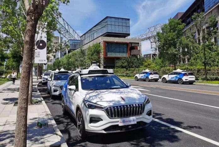 Photo shows autonomous vehicles of Chinese tech giant Baidu parked at the New Shougang High-end Industry Comprehensive Service Park in Beijing. (Photo by Du Yifei/People’s Daily)