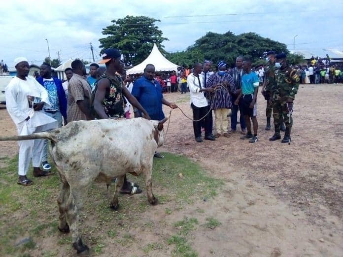 Lt Col Kwesi Gyimah receiving the cow from Naa Kardri Ibrahim, Wa Naa's Spokesperson