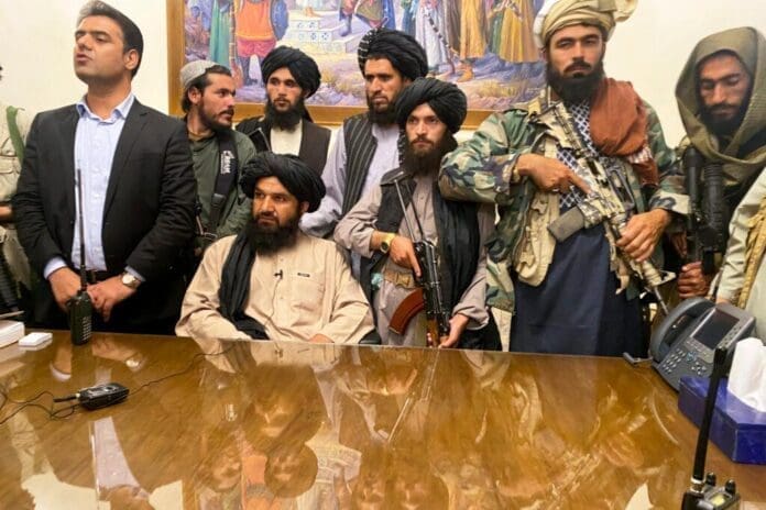 Taliban fighters take control of Afghan presidential palace after the Afghan President Ashraf Ghani fled the country, in Kabul, Afghanistan, Sunday, Aug. 15, 2021. (AP Photo/Zabi Karimi)