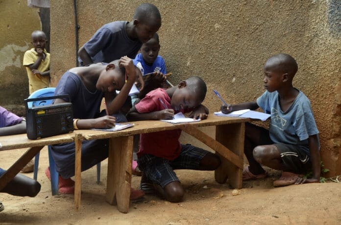 Children listen to a radio program in Kampala, Uganda, June 14, 2021 following the closure of schools due to the COVID-19 pandemic. (Photo by Nicholas Kajoba/Xinhua)