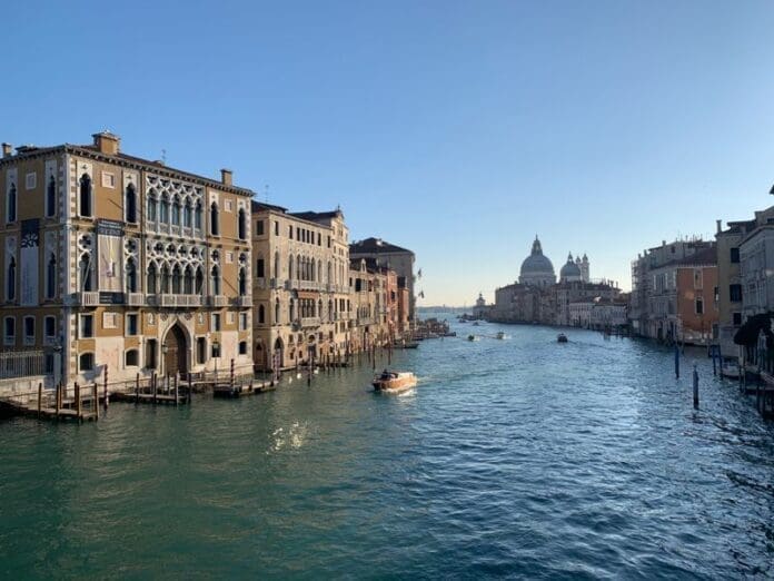 FILED - 07 February 2020, Italy, Venice: A boat sails down Venice's the Grand Canal. Storms and strong winds have prompted Italian authorities to activate the city's so-called Mose flood defence system, according to a tweet from Mayor Luigi Brugnaro. Photo: Annette Reuther/dpa FILED - 07 February 2020, Italy, Venice: A boat sails down Venice's the Grand Canal. Storms and strong winds have prompted Italian authorities to activate the city's so-called Mose flood defence system, according to a tweet from Mayor Luigi Brugnaro. Photo: Annette Reuther/dpa
