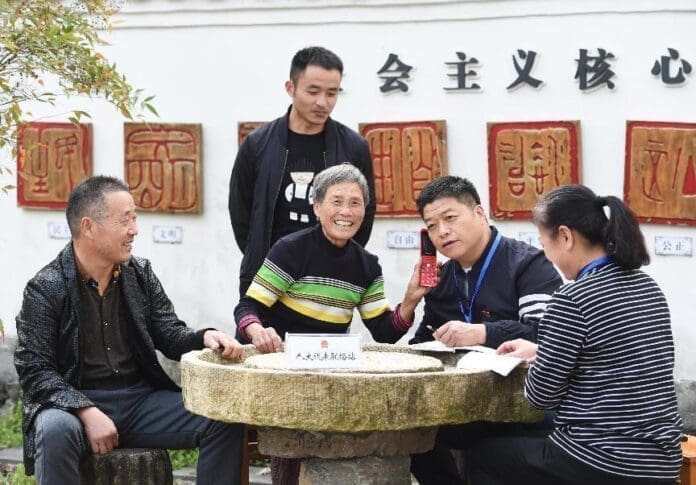Deputies to the people’s congress solicit opinions from voters in Longma village, Lin’an district, east China’s Zhejiang province, Oct. 26, 2021. (Photo by Jin Kaihua/People’s Daily Online)