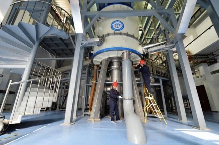 Scientific staff adjust the Steady High Magnetic Field Facility at the High Magnetic Field Laboratory, Chinese Academy of Sciences, Heifei, east China's Anhui province. (Photo by Xu Minhao/People's Daily Online)