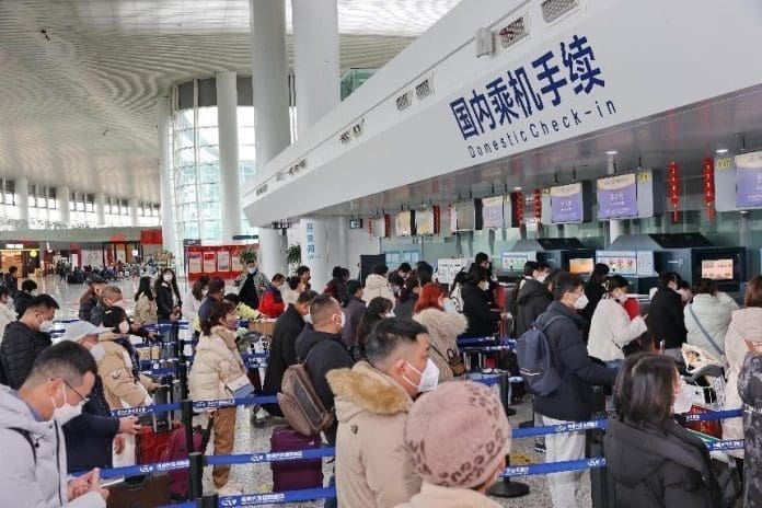 Passengers wait in lines to check in at Nantong Xingdong International Airport, east China's Jiangsu province, Jan. 12, 2023. (Photo by Xu Congjun/People's Daily Online)